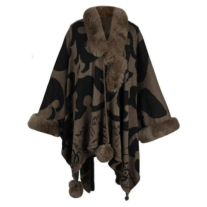 Luxurious faux fur shawl in dark tones with fur collar and pom-pom details, perfect for elegant winter style.