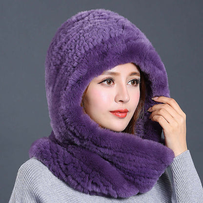 Woman wearing a luxurious purple faux fur hat with scarf, exemplifying warmth and winter style.