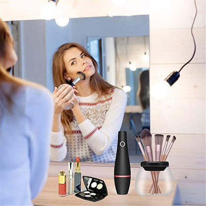 Woman using Makeup Brush Cleaning Machine with makeup tools on vanity for effortless beauty routine.