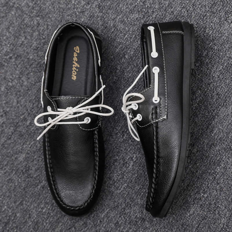 Black faux leather loafers with white laces, offering classic style and comfort, ideal for everyday wear.