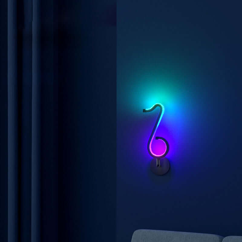 Modern neon wall decor illuminating a dark blue room with colorful light.