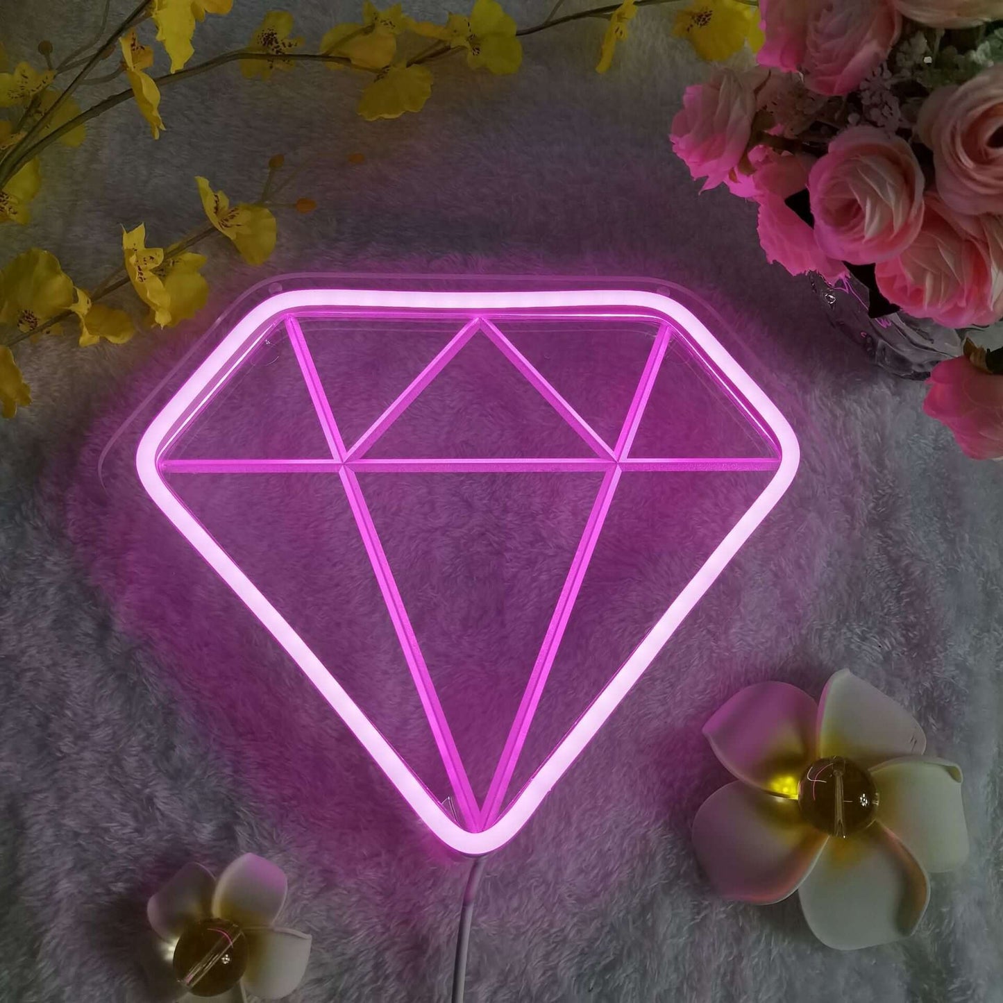 Pink neon decorative night light shaped like a diamond, adding vibrant style and ambiance to any room.