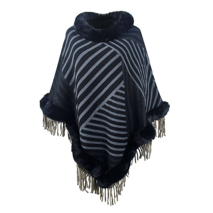 Stylish poncho coat with fur trim and fringe, featuring a modern striped design for luxurious comfort and elegance.