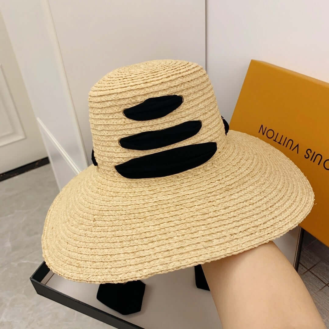 Stylish Raffia Big Brim Hat with black accents, perfect for summer outings and sun protection.