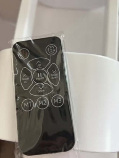 Remote control for easy operation of the Anti Gravity Water Droplet Humidifier, featuring buttons for various functions.