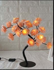 Rose Small Tree Lamp illuminating a room with soft, ambient light, featuring elegant rose-shaped lights on a stylish black base.
