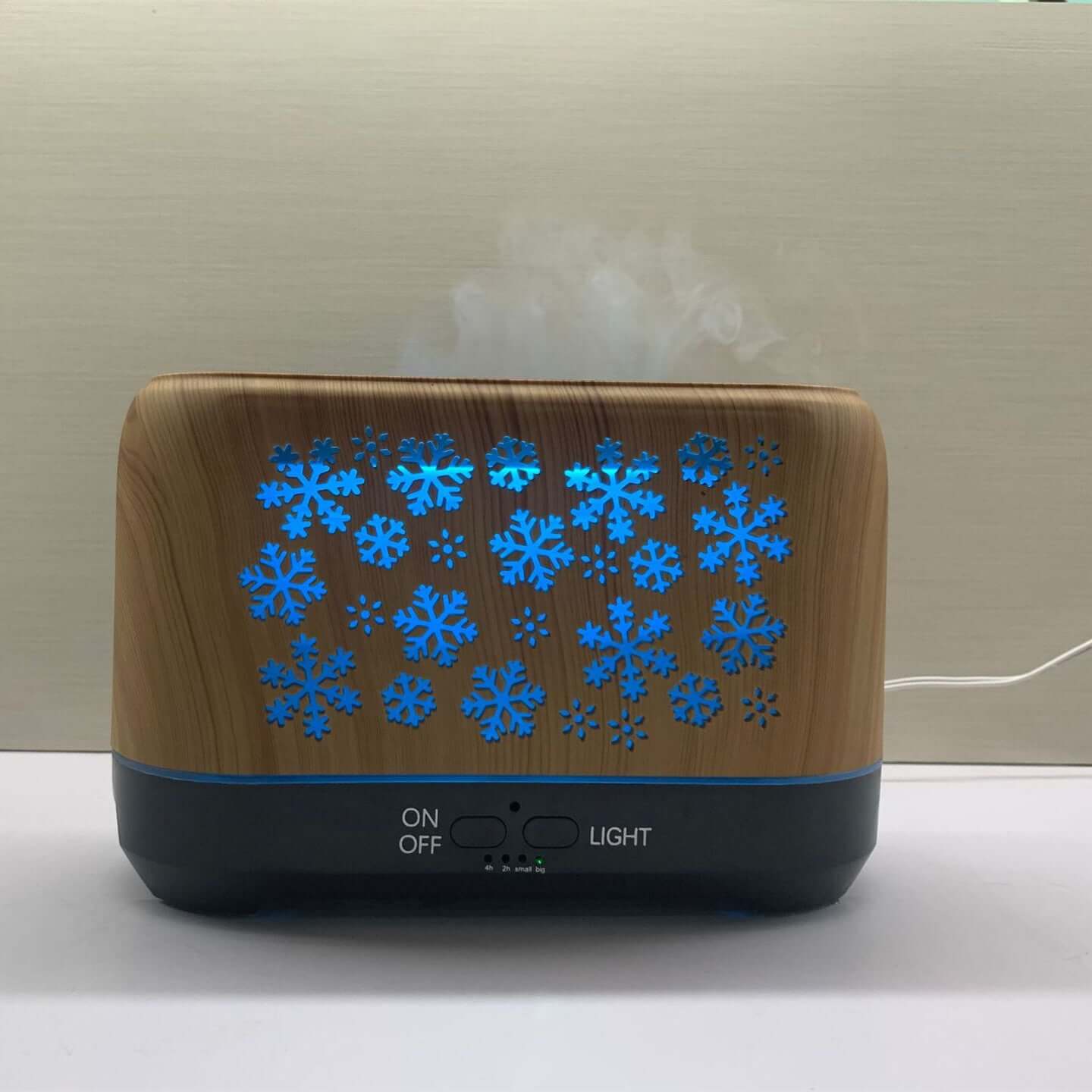 Snowflake Humidifier emitting mist with a stylish snowflake design and blue light accents.