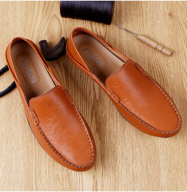 Soft Bottom Leather Loafers in brown, casual design with round toe, showcasing premium craftsmanship on a wooden background.