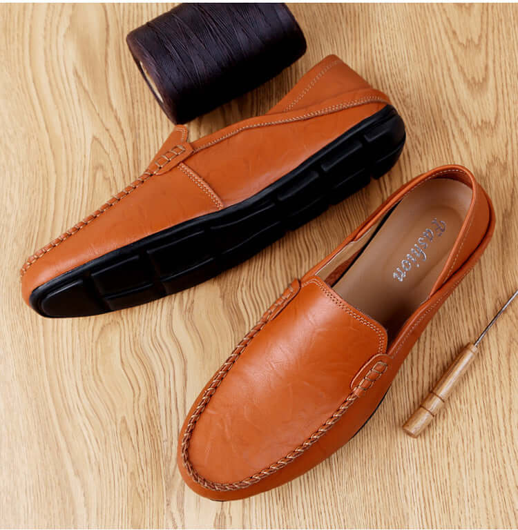 Stylish yellow brown soft bottom leather loafers with round toe design, showcasing premium craftsmanship on wooden floor background.