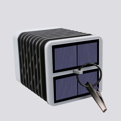 Rectangular solar-powered lantern with key hook for outdoor illumination.