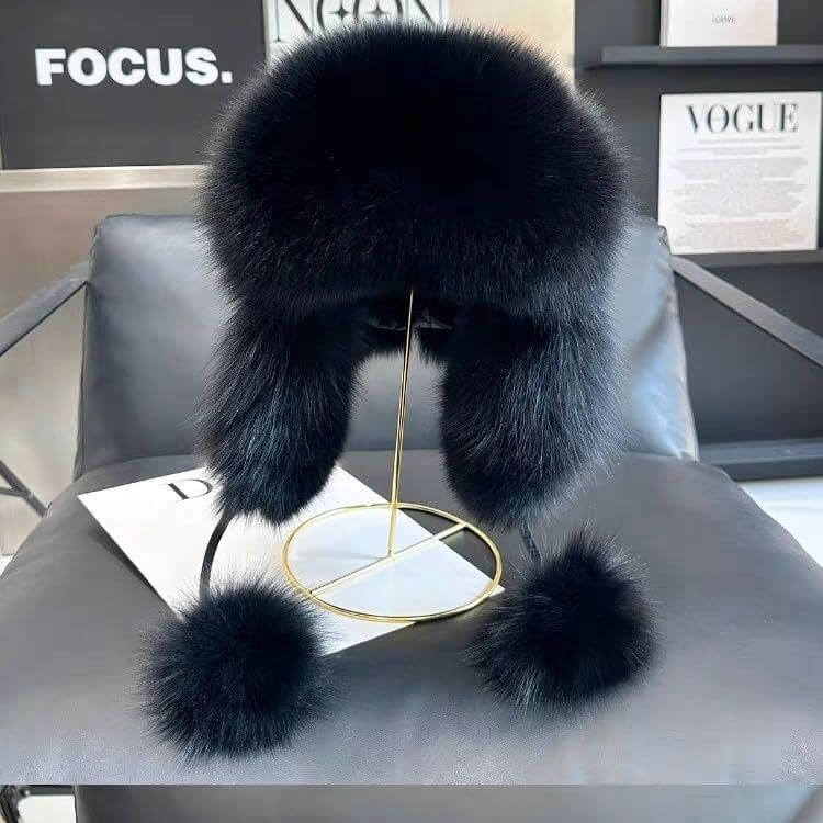 Stylish black Ushanka fur hat displayed on a stand, showcasing winter fashion and warmth.