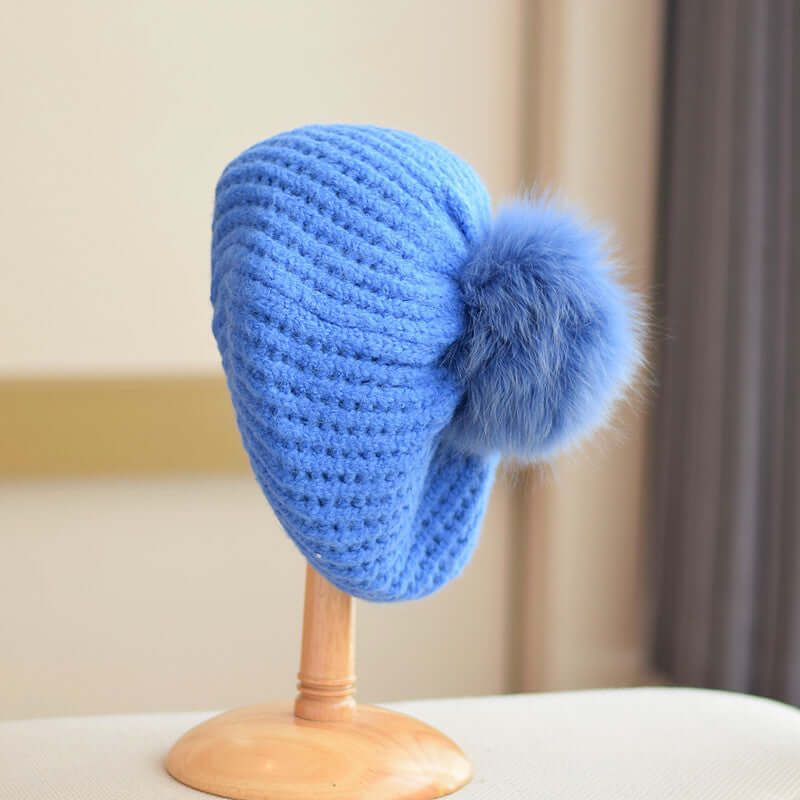 Light blue Fur Ball Hat featuring a stylish pom-pom, perfect for winter warmth and fashion.