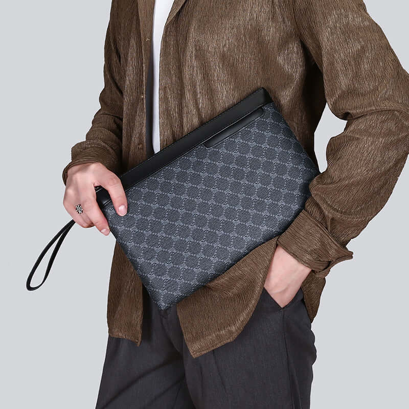 Elegant clutch hand bag in classic black PU material, held by a person in casual wear, showcasing its versatility and style.