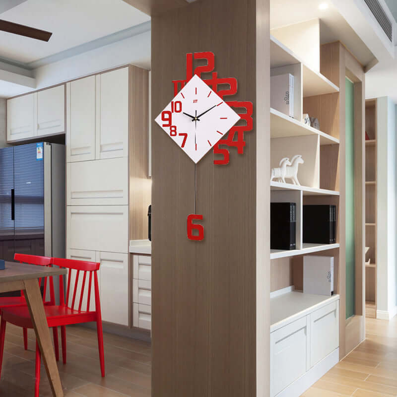 Stylish wall clock with a modern design, featuring red numbers, hanging on a wall in a contemporary kitchen setting.