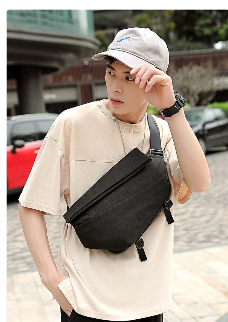 Young man wearing Crossbody Multifunctional Bag in Charcoal Black, highlighting modern design and versatility for everyday use.