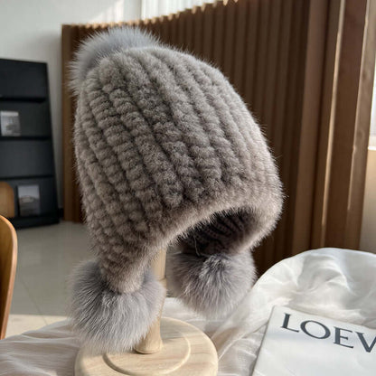 Stylish Ear Muffs Hat with fur pom-poms, perfect for staying warm and fashionable this winter.