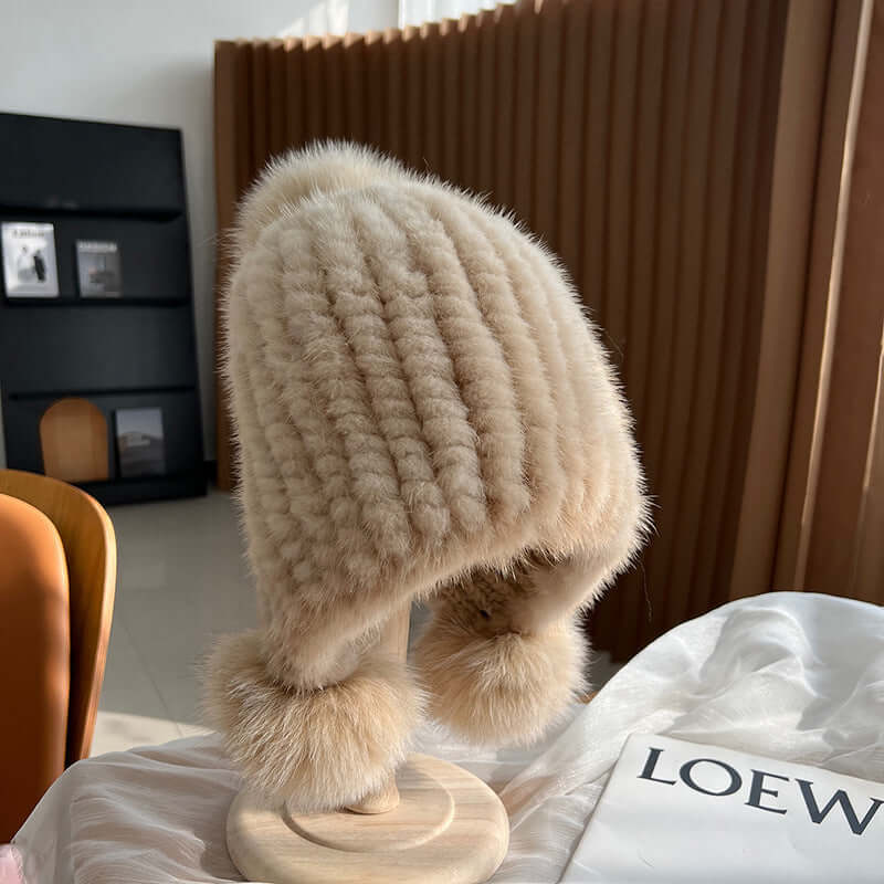Stylish Ear Muffs Hat in soft beige fur, perfect for winter warmth and chic fashion.