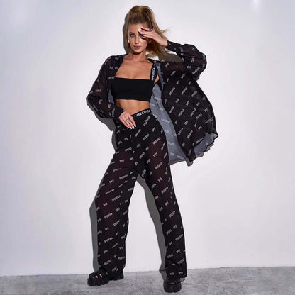 Woman wearing a stylish jumpsuit with chiffon featuring unique text design, highlighting trendy fashion and elegance.