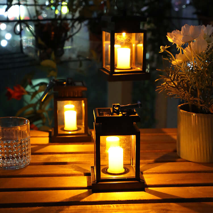 Cozy setting with glowing wind up lanterns on a wooden table, creating a warm ambiance in an outdoor space.