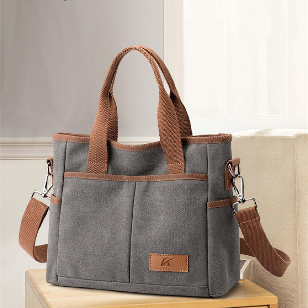 Gray Simple Tote Bag made of durable canvas, featuring brown handles and a versatile design. Ideal for daily use. Available in multiple colors.