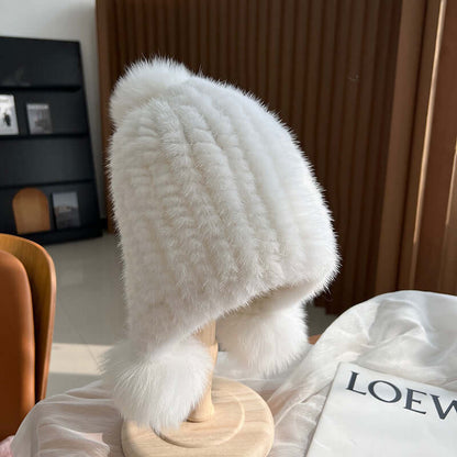 Stylish white Ear Muffs Hat displayed on a stand, featuring soft faux fur and a cozy design for winter warmth.