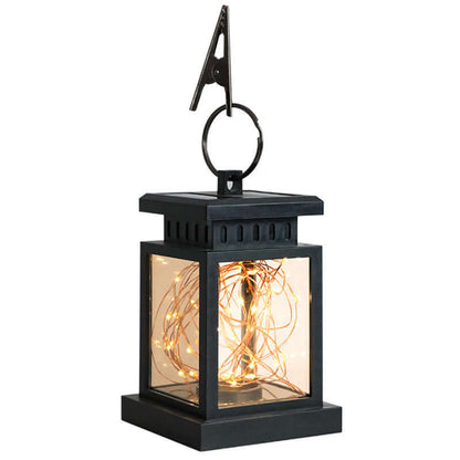 Black wind up lantern with glowing lights inside, perfect for eco-friendly outdoor lighting solutions.