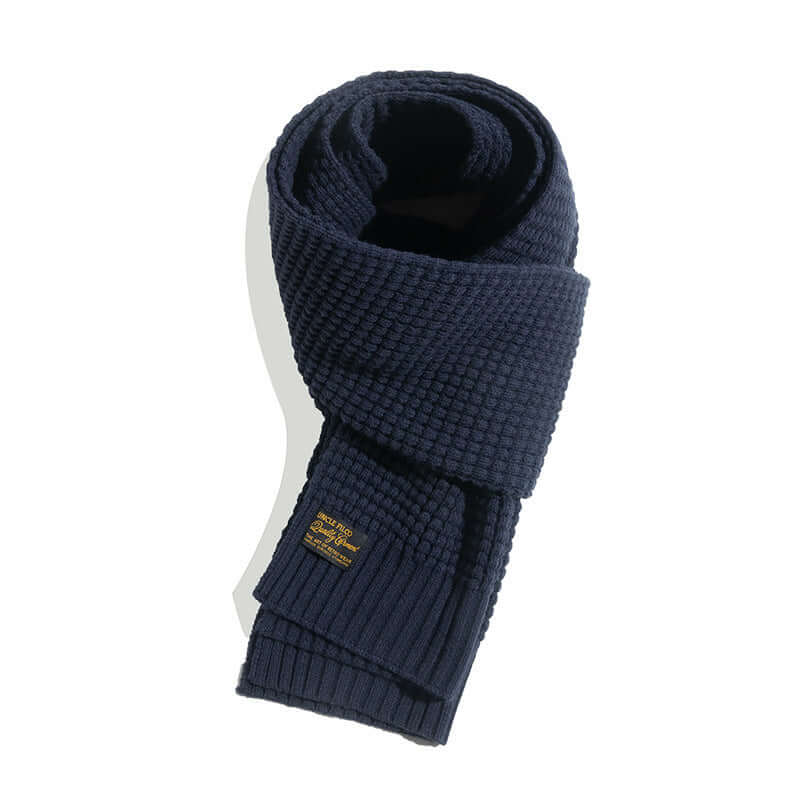 Elegant wool knitted scarf in deep blue, perfect winter accessory for warmth and style.