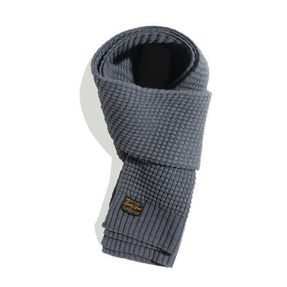 Stylish wool knitted scarf in classic gray, perfect winter fashion accessory for warmth and style.